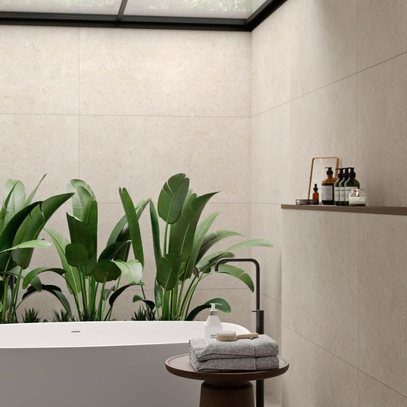 Modern bathroom with beige large format porcelain tiles on the walls.