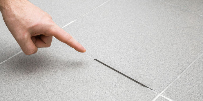 Tile with damaged grout.