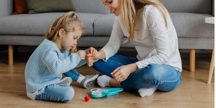 Mother and child having fun with nail polish