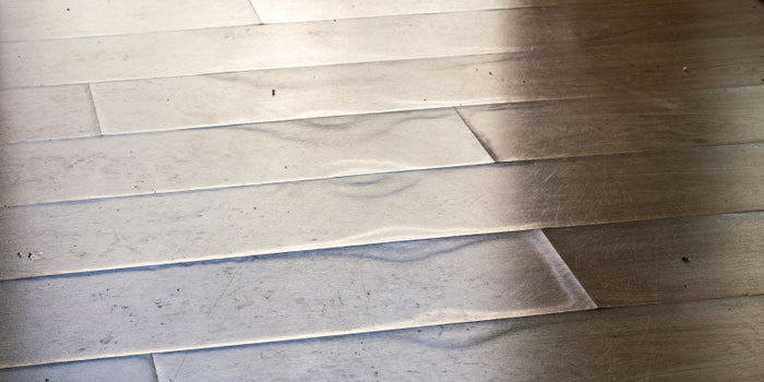 Close-up of a floor with visible delamination.