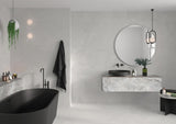 Modern bathroom with black freestanding bathtub and Spanish white porcelain tile on the walls and floor
