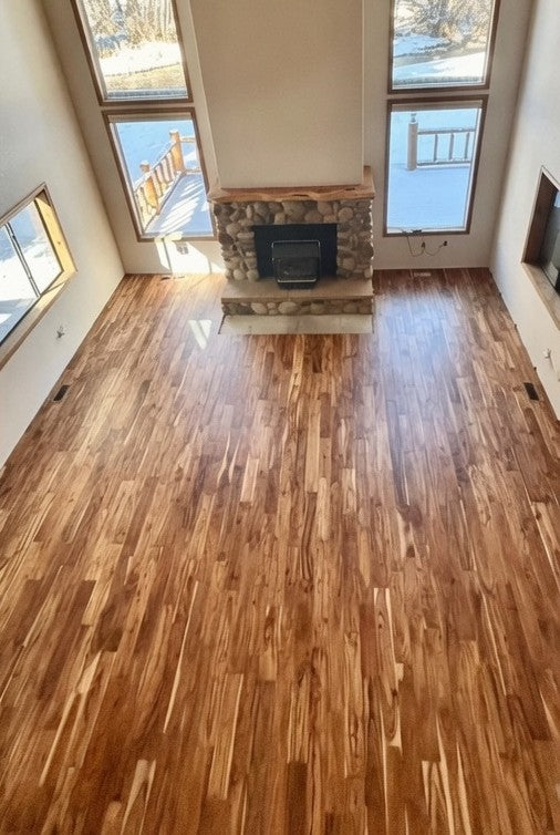 The same living room after the carpet was replaced with hardwood flooring