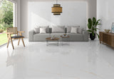 A modern living room featuring glossy white marble-look porcelain floor tiles with subtle gold veining, a light gray sofa, a